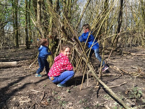 children building a bivouac outdoors